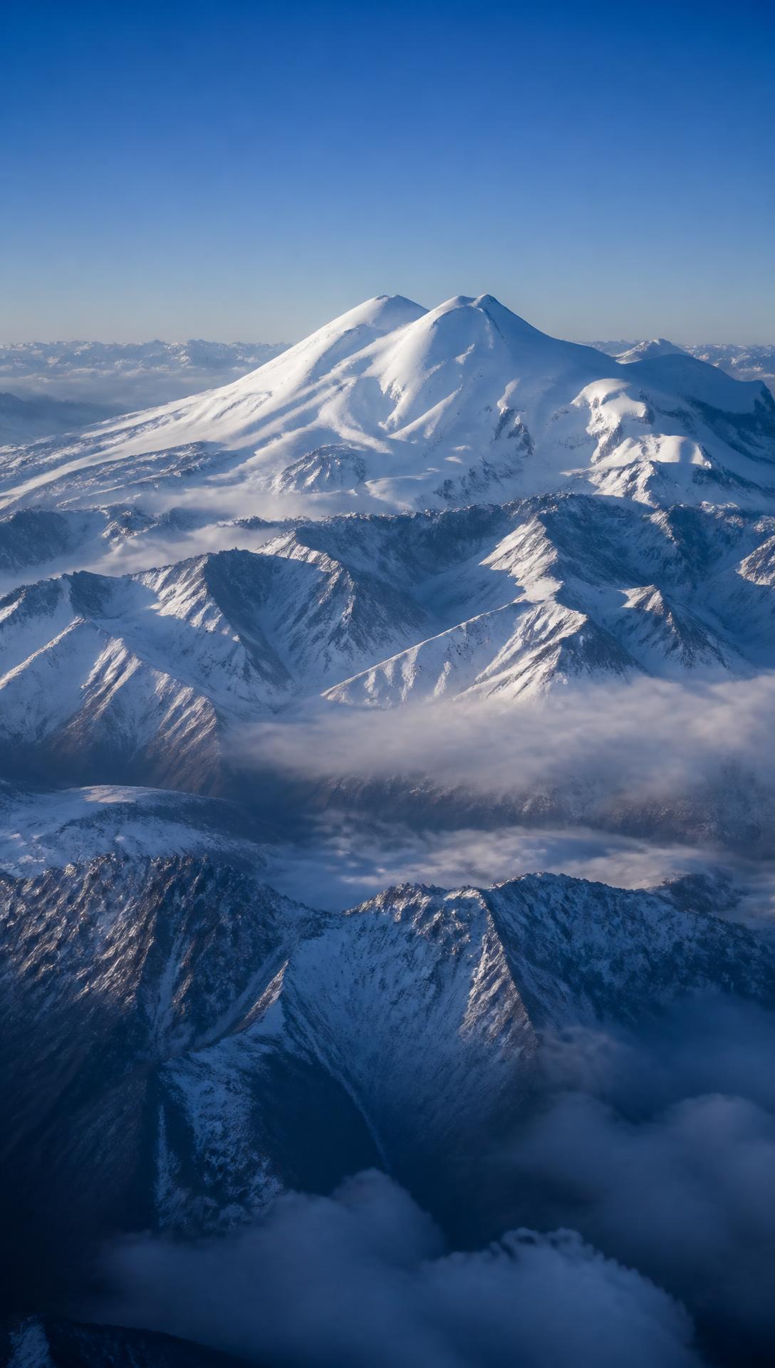 Snow-capped peaks of Mount Elbrus in the Caucasus at dawn